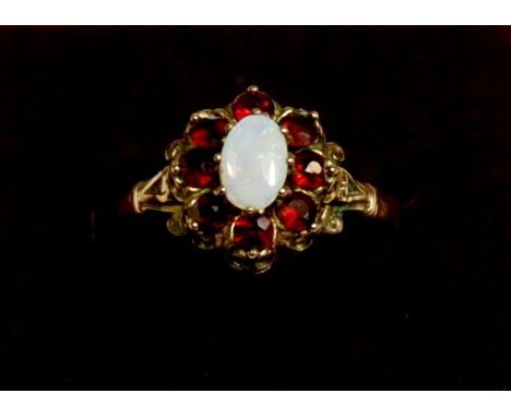 A 9 carat gold cluster ring set opal and garnets, size N to O, 2.4g 