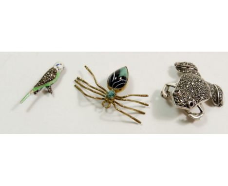 A silver marcasite frog brooch 4cm long, a silver enamel and marcasite budgerigar brooch and a gilt metal spider brooch 