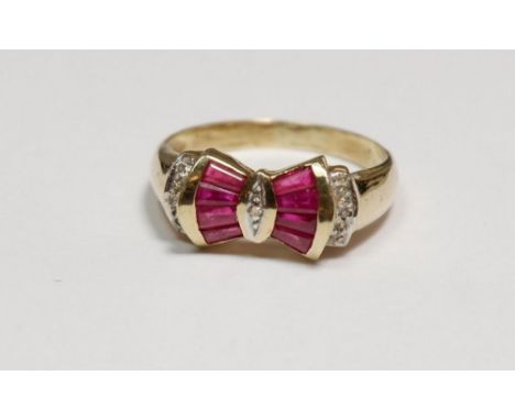 A 9 carat gold ring set ruby and diamond bow, size N, 2.5g 