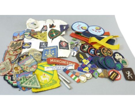 A box of fabric and enamel Girl Guide badges