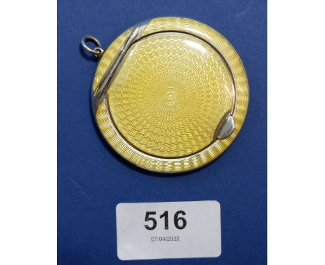 A silver and yellow enamel compact, 5.5cm diameter with pendant ring