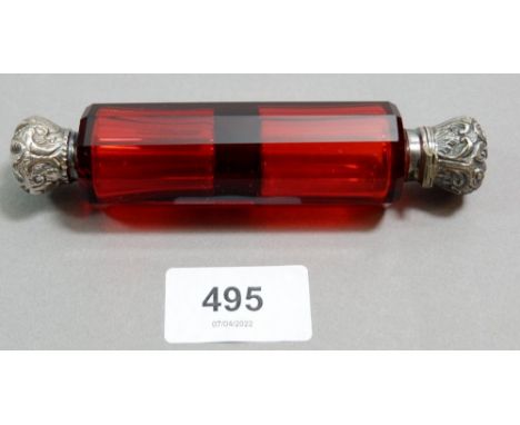A Victorian ruby glass double ended scent bottle with embossed white metal hinged and screw top ends, 12.5cm 