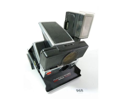 A Polaroid SX70 land camera with flash 
