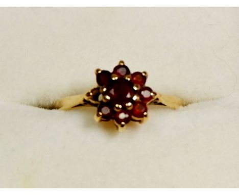 A 9 carat gold garnet cluster ring, size L to M 