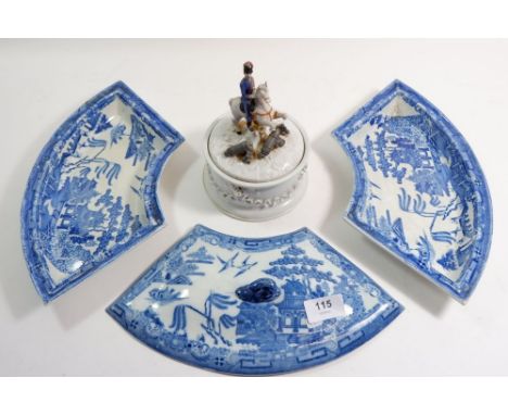 A pair of 19th century blue and white segment dishes and one lid and a pot and lid with soldier finial 