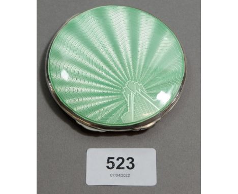 A silver and green enamel compact with Art Deco sunray decoration, Birmingham 1938, Maker William Neale &amp; Son. 107g 