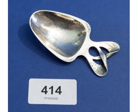 A silver hammered Arts and Crafts Liberty caddy spoon 'Cymric' by Archibold Knox 