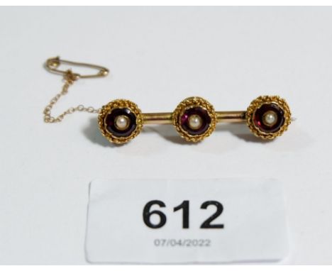 A Victorian yellow metal brooch set three amethyst and three seed pearls 