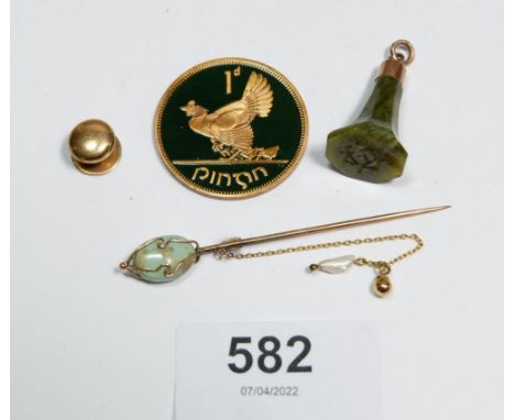 A 9 carat gold mounted green stone seal 2.8cm, a 15 carat gold stud 1.4g, a yellow metal and turquoise stick pin and a Irish 