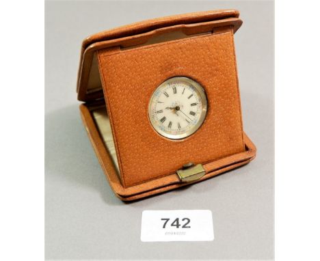 A silver fob watch with floral enamel dial in leather folding watch holder 