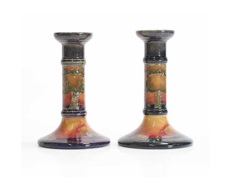 William Moorcroft (1872-1945), a near pair of 'Eventide' candlesticks, c.1925, for Moorcroft Pottery, glazed earthenware, eac