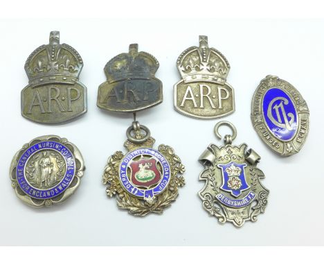 Two silver and enamelled Derbyshire sports fob medals, two silver nursing badges including one by Gaunt and three silver ARP 