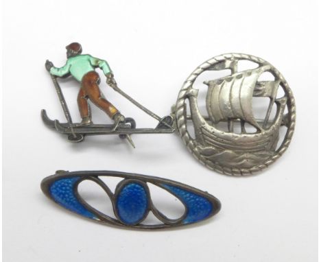 A silver and enamel cross-country skier brooch, marked Norne 925S, slight damage on right arm, a hallmarked silver and enamel