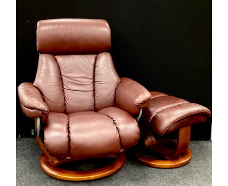 A Global Furniture Alliance faux leather stressless reclining armchair with matching footstool, 105.5cm high, 88cm wide, 56cm
