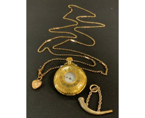 A Fancy link gold filled guard chain, stamped warranted gold filled, 140cm long, terminating with a yellow metal heart pendan