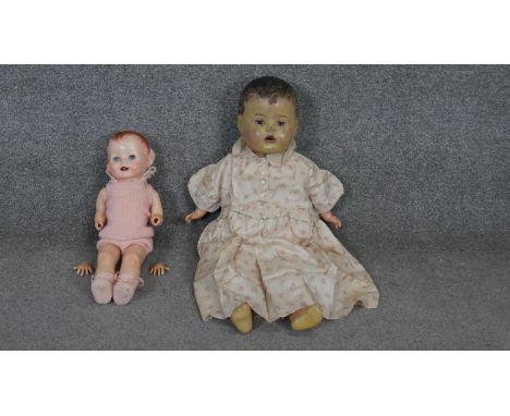 Two vintage dolls. A vintage composition doll by DEE and CEE, Canada in a night dress along with a palstic doll with moving e