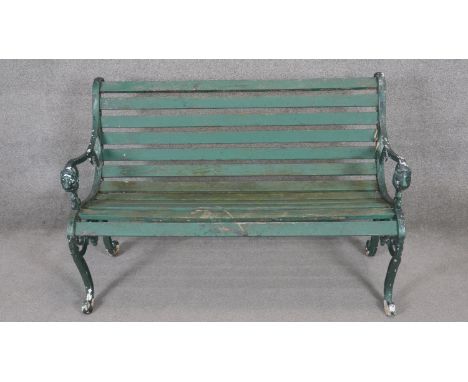 A vintage painted iron garden bench with slatted seat. H.84 x W.125 x D.64cm 