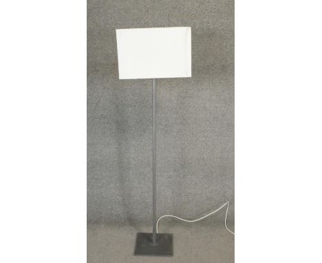 A contemporary metal standard lamp with linen block shade. H.142cm 