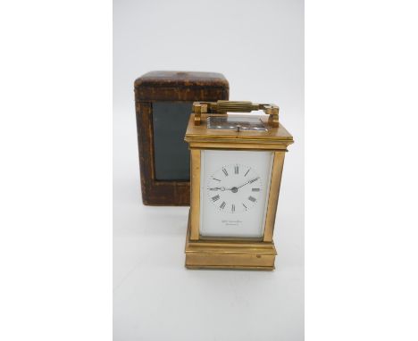 A brown leather cased Georgian gilt bronze and bevelled glass carriage clock by Whitehead &amp; Sons, Sevenoaks. White enamel
