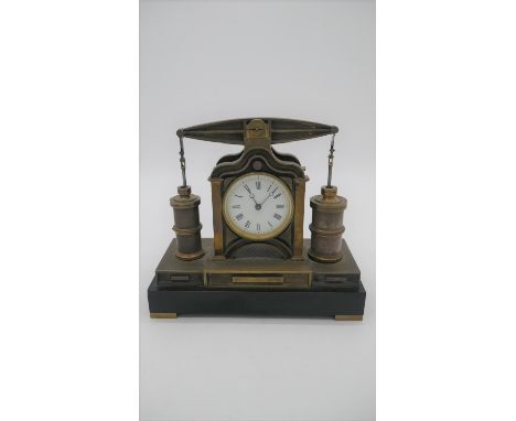 A 19th century French industrial mantel clock. Two industrial engine type pistons flank the clock. They attach to a rocking b