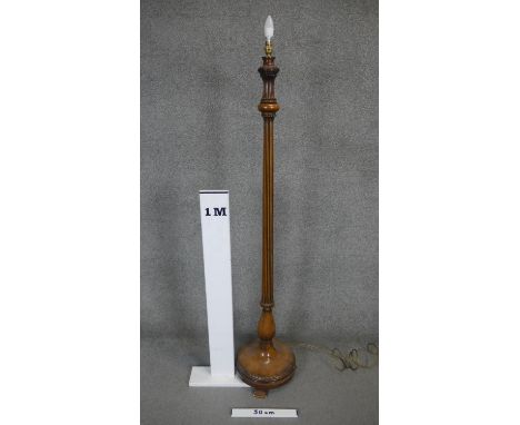 A mid century carved walnut lamp standard with reeded column on platform base. H.166cm 