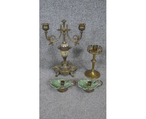 A brass and porcelain twin branch candelabra, a pair of brass chambersticks and a Gothic brass candlestick. 