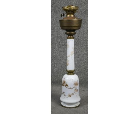 A Sherwood milk glass hand painted oil lamp. Gilded with ivy leaves, brass fittings and pierced gallery. H.68cm 