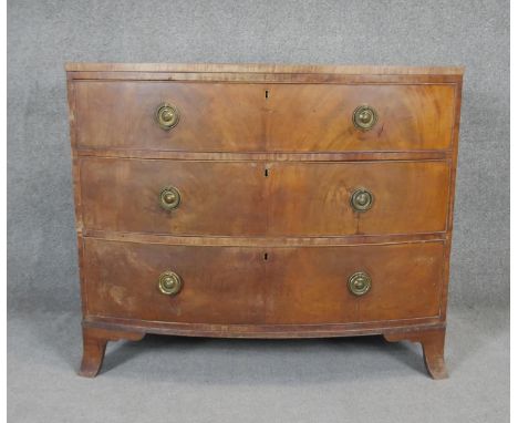 A Regency flame mahogany bow fronted chest of drawers on swept bracket feet. H.87 W.103 D.50 