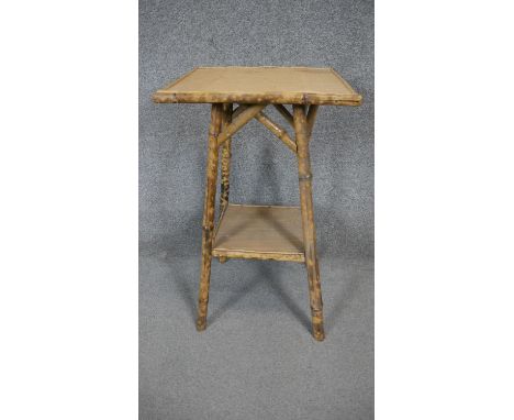 A vintage two tier bamboo occasional table. H.66 Dia.39cm 