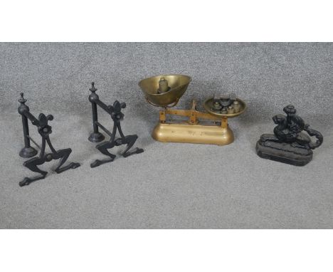 A collection of metalware. Including a pair of cast iron firedogs, a set of brass weighing scales by G.Haynes and Sons and a 