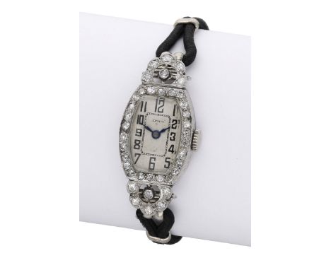 Efico. A lady’s platinum and diamond-set tonneau-form cocktail watch, circa 1930. Movement: manual winding. Dial: silvered, A