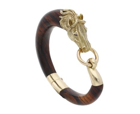 A horse bracelet, French, circa 1970, the polished wood cuff with realistically modelled horse head terminal with cabochon ha