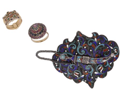 An early 20th century Russian buckle and two gem set rings, the silver buckle with blue, white and red cloisonné enamel decor