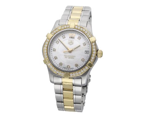 Tag Heuer. A lady’s stainless steel, gold and diamond-set wristwatch with date, mother-of-pearl dial and bracelet, Ref. WAF13
