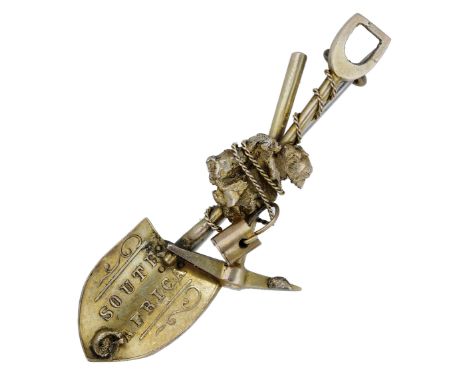 A gold Prospector’s brooch, fashioned as a miner’s shovel, stamped ‘SOUTH AFRICA’, crossed with a pick axe, bucket, chain and