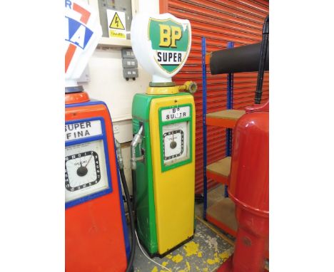 An Avery Hardoll electric petrol pump with hose and nozzle, restored many years ago in BP colours, surmounted by a reproducti