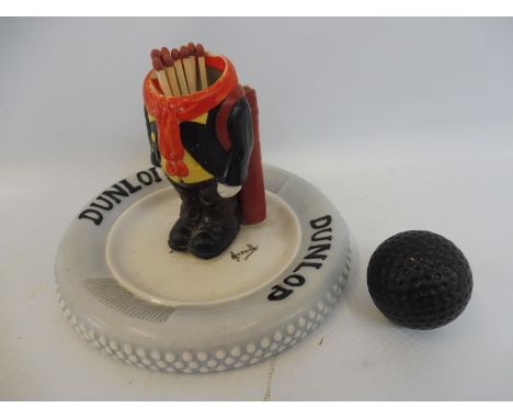 A Dunlop Tyres ceramic golfer matchstriker ashtray with detachable golf ball head, signed by Hassall. 