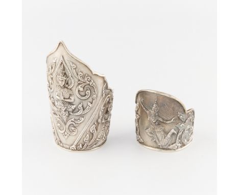 Group of two Siamese sterling cuff bracelets. The larger featuring a central motif of a Siamese Buddha, swirls, and two ancil