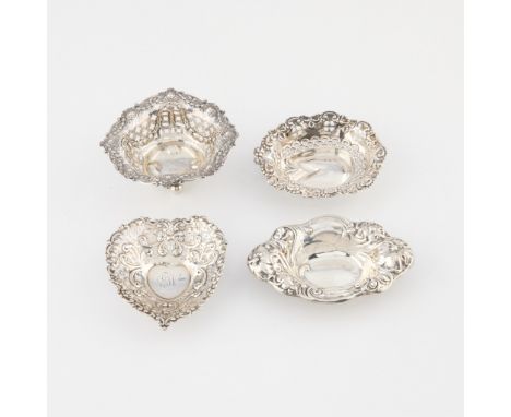 Four small sterling dishes.One of oblong form with Art Nouveau style floral border, marked sterling by Frank M. Whiting &amp;