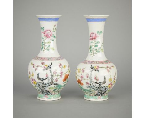 Pair of Chinese Republic period famille rose porcelain bud vases depicting flowers and birds, ca. 1890-1914. With bands of a 