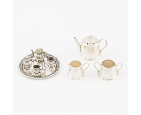 Group of two miniature sterling silver tea sets including:One miniature tea set in a fitted antique case containing a tray, t