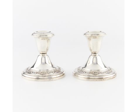 Pair of Gorham sterling silver candlestick holders with cement filled bases. With ornate scrolling along the base rim. Marked