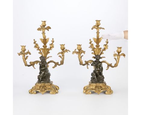 Set of two French Louis XVI style gilt bronze candelabras, 19th-20th century. With candlestick holders and bobeche cups in th
