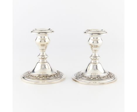 Gorham sterling silver candlestick holders with weighted bases. With ornate scrolling along the base rim. Marked along the ba