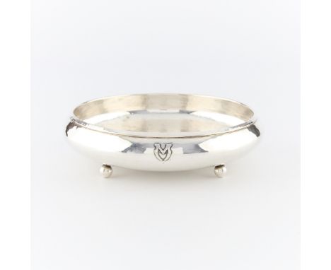 Lebolt &amp; Co., United States. Sterling silver shallow hammered bowl on four spherical feet and with applique M along the e