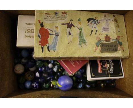 A 19th Century box containing glass marbles, playing cards etc. 
