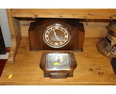 A 20th Century oak barometer; and an oak veneered two hole  mantel clock 