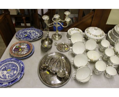 A quantity of silver plated ware to include a candelabra, sauceboat, chamber stick etc. 