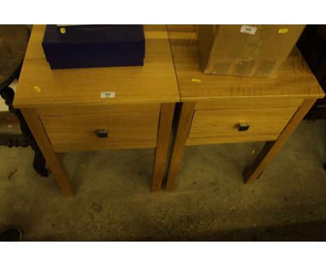 A pair of light oak single drawer bedside tables