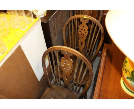 Seven elm seated stick and wheel back kitchen chairs to include two carvers